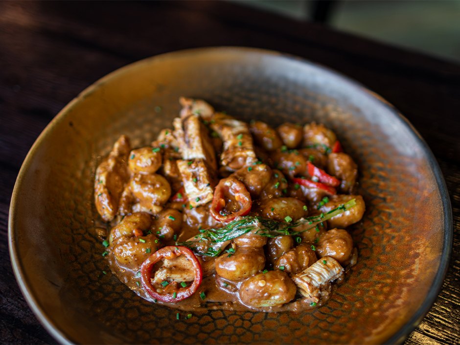 Gnocchi with grilled chicken, sweet peppers, rapini and mole cream sauce.