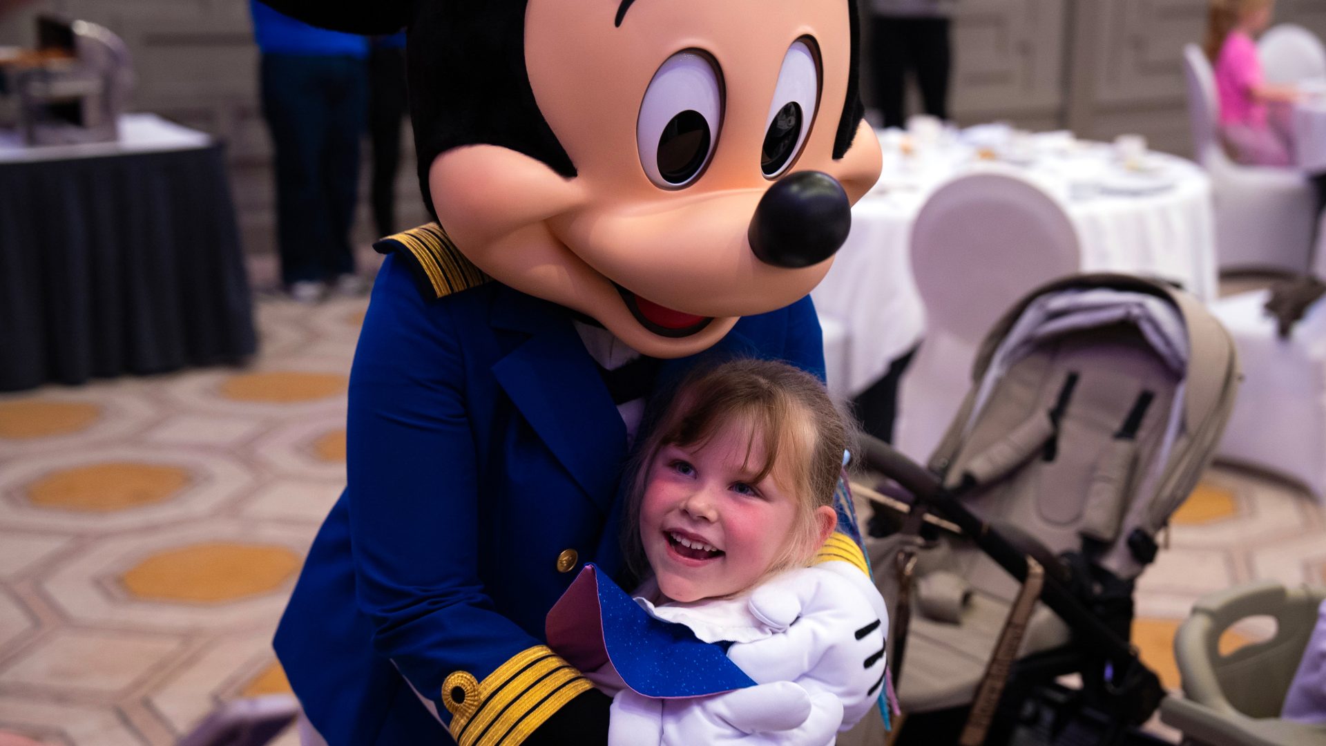 Mickey Mouse with a young guest during the Disney Dream wish-family gathering