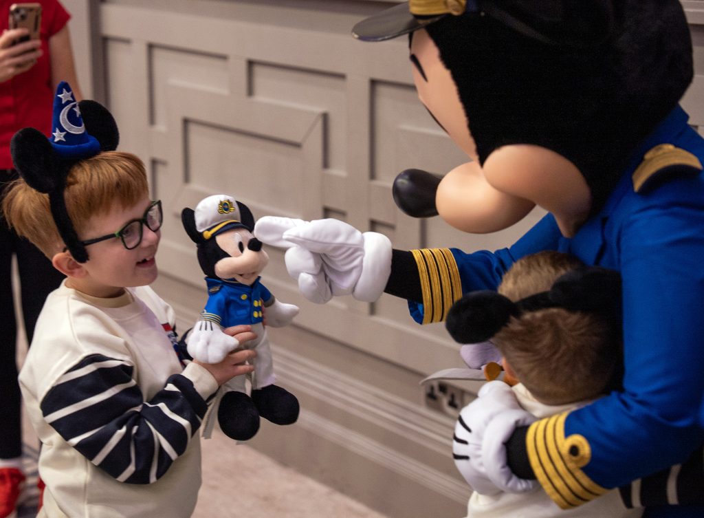 Mickey Mouse greeting young guests aboard Disney Dream