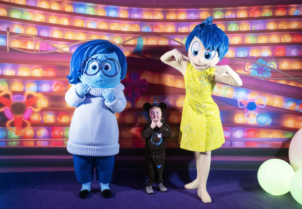 Joy and Sadness with a young guest at the wish-family gathering
