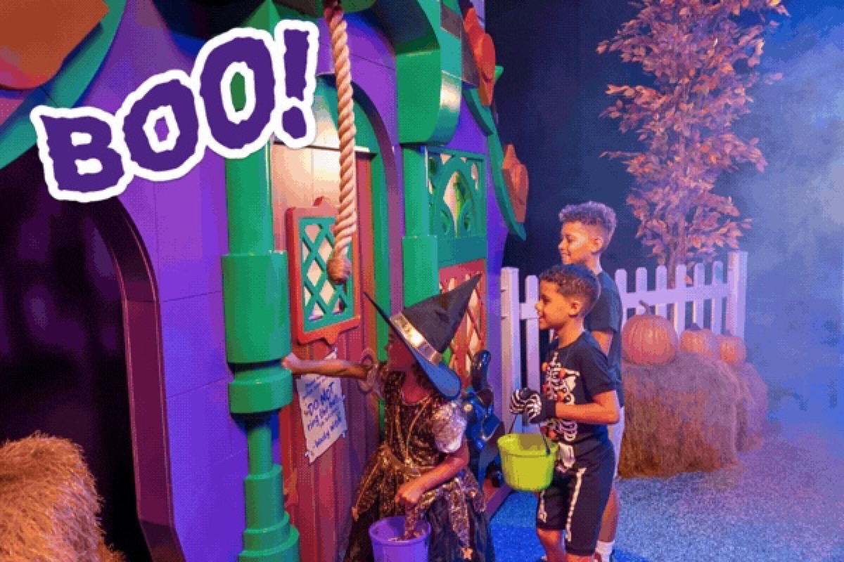 Children visit a colorful monster house inside Brick or Treat Street at LEGOLAND Florida