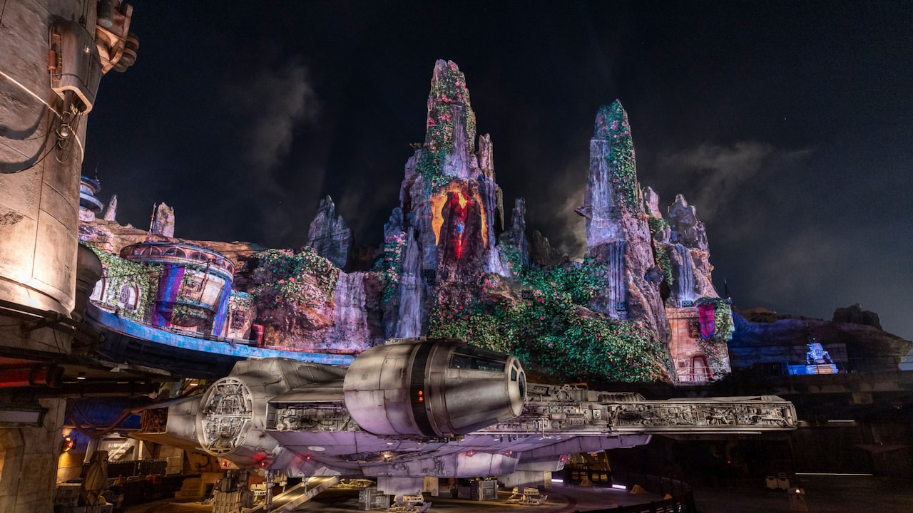 The Millennium Falcon and the spires of Batuu at Star Wars: Galaxy’s Edge in Disneyland Park