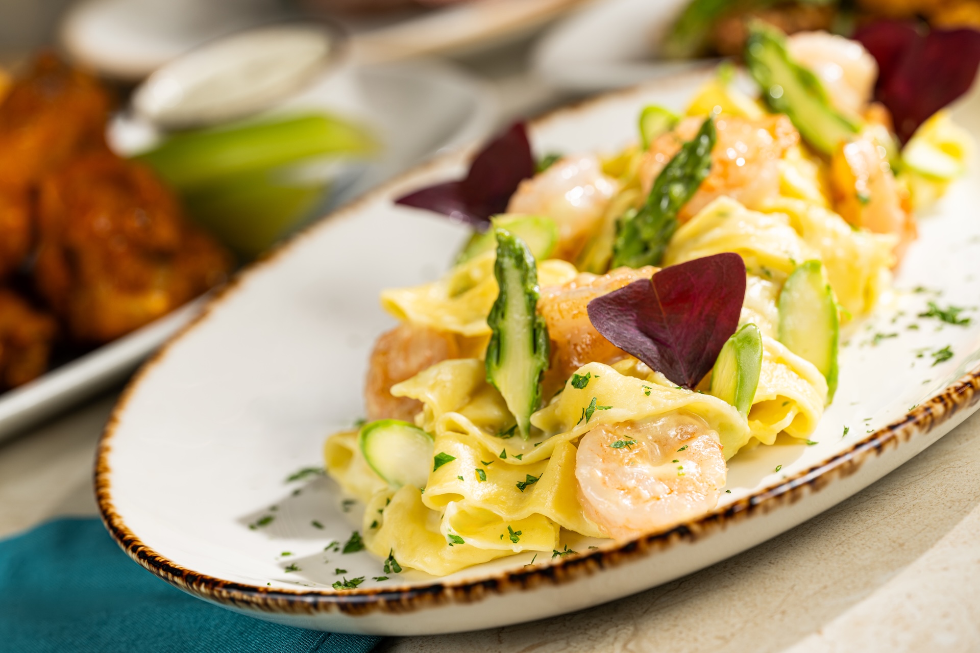 Pasta with vegetables on a long plate