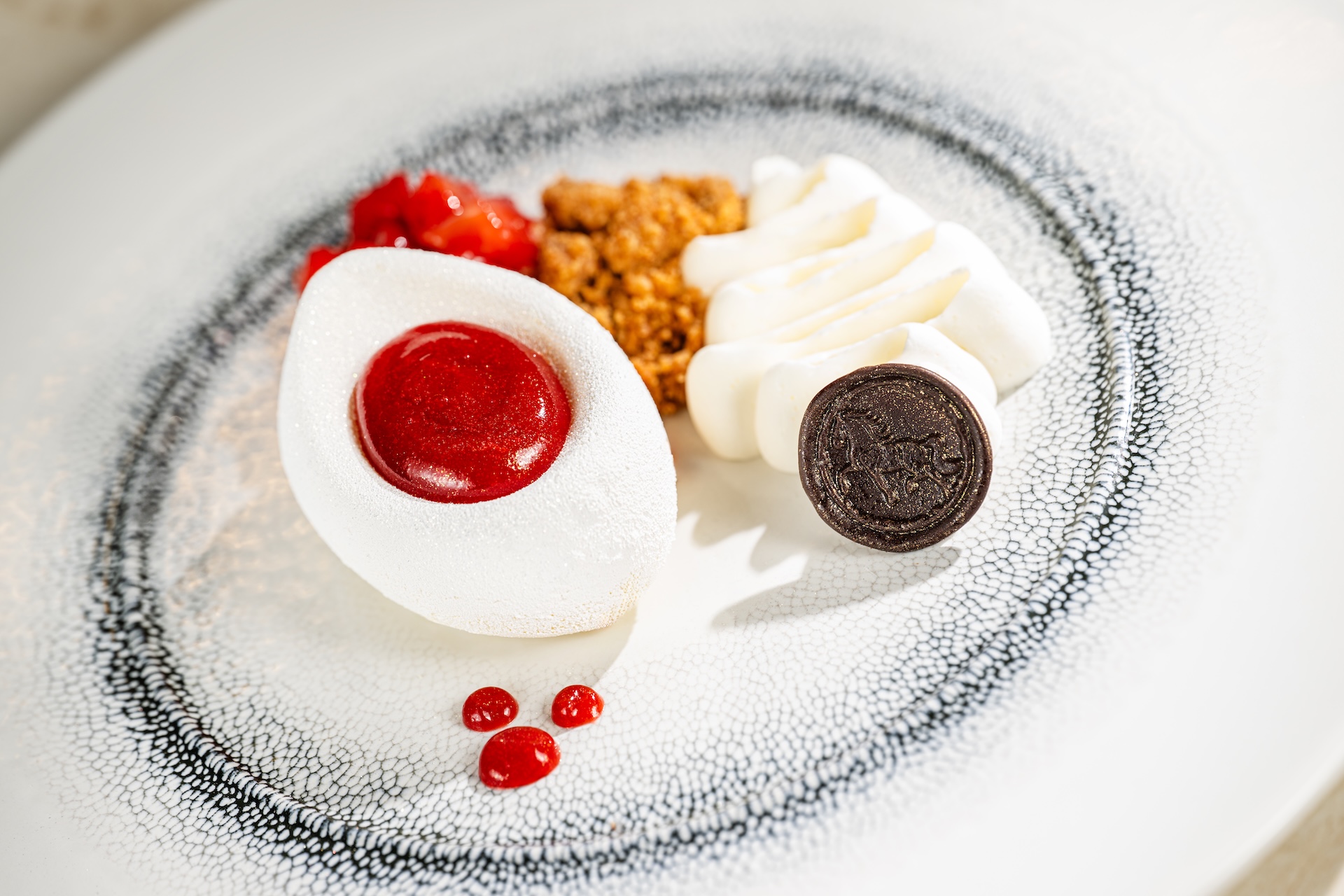 New York-style cheesecake with cream and berry sauce
