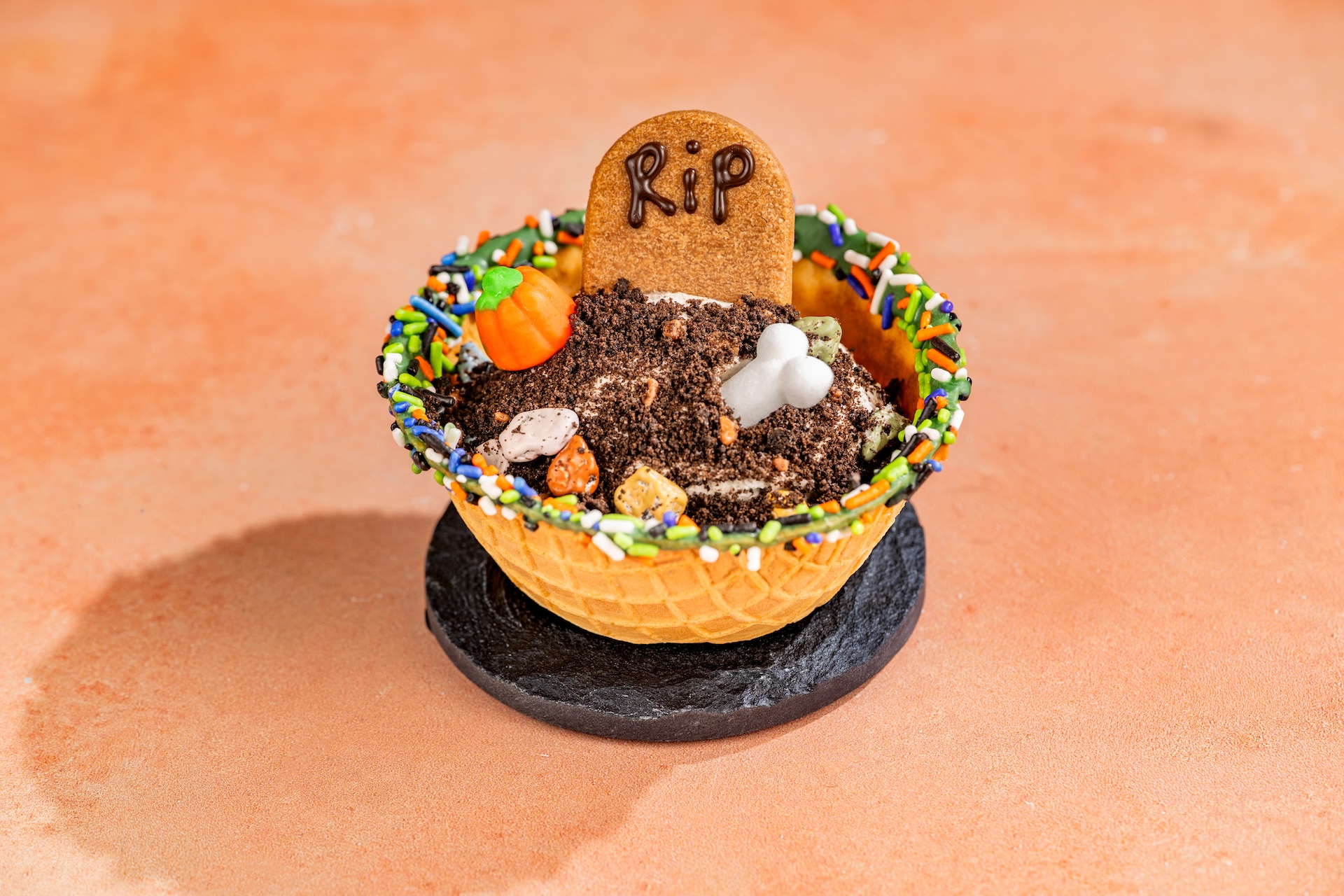 Boneyard Cookies and Scream Sundae topped with a tombstone cookie, candy pumpkin, sugar bone and Halloween sprinkles