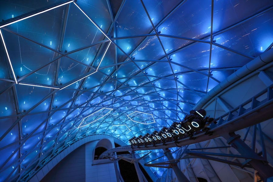 TRON Lightcycle / Run trains beneath the glowing canopy at Magic Kingdom