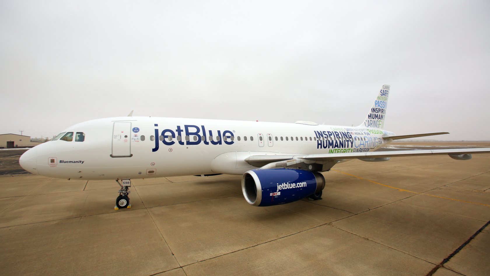 A JetBlue Airbus A320 parked on an airport ramp