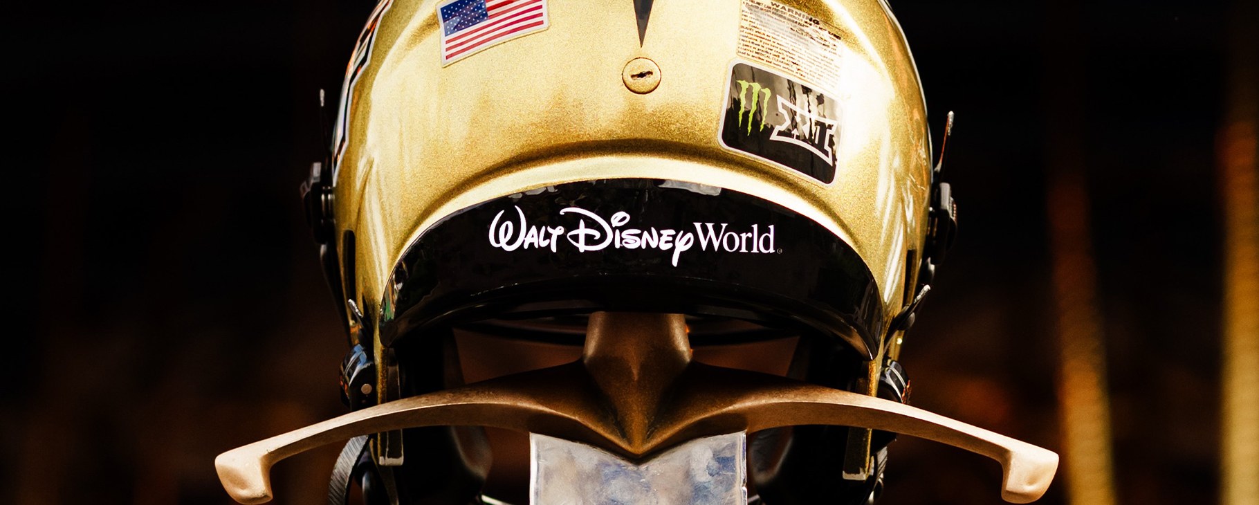A gold UCF football helmet carries the Walt Disney World logo on its rear bumper