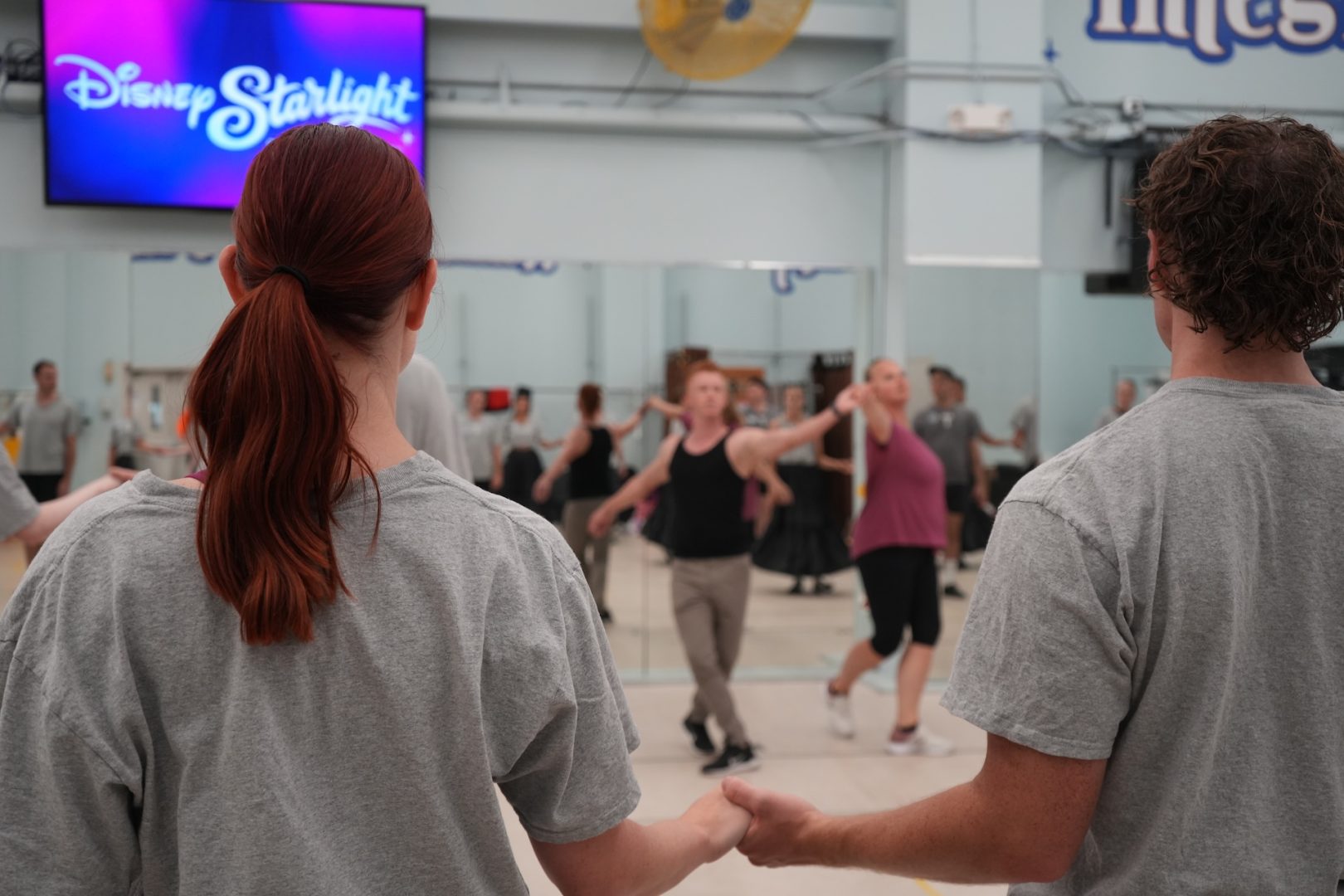 Maintenance choreographers watch Disney Starlight performers rehearse in a mirrored studio at Walt Disney World