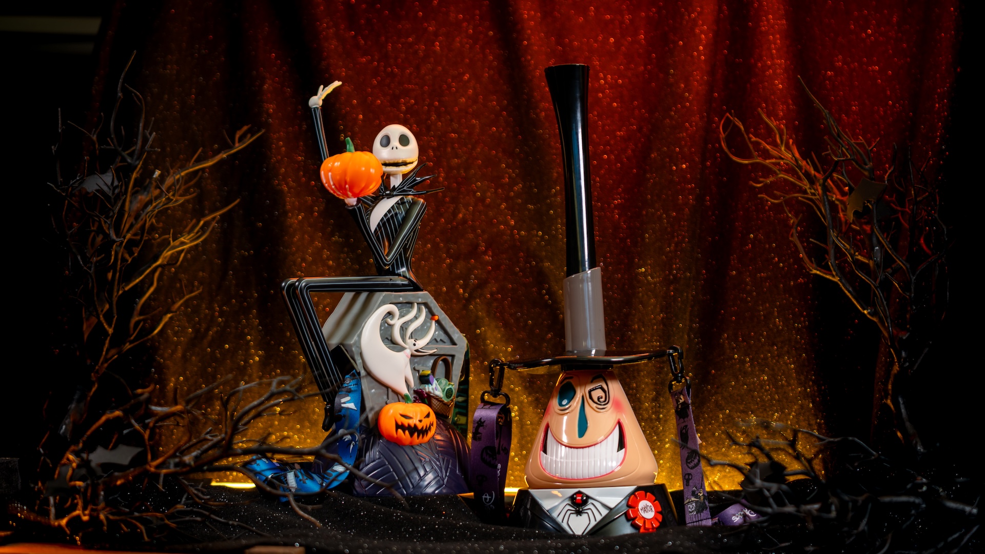 Jack Skellington gravestone popcorn bucket and Mayor sipper displayed in a Halloween setting