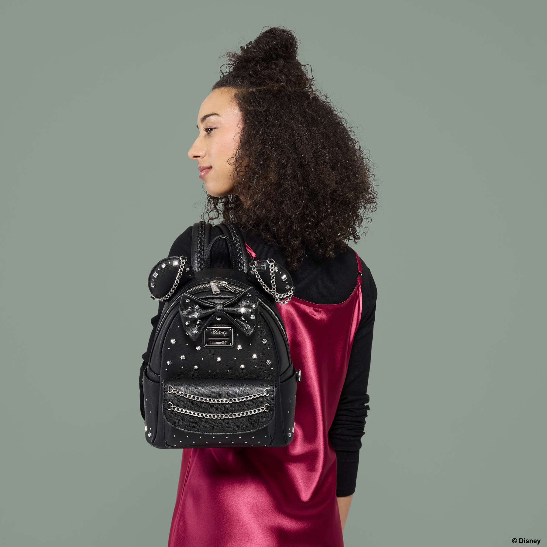 Minnie Mouse Studs and Chains mini backpack worn over a pink dress