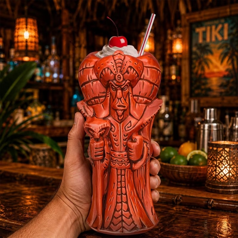 Hand holding the orange Jafar Geeki Tikis mug