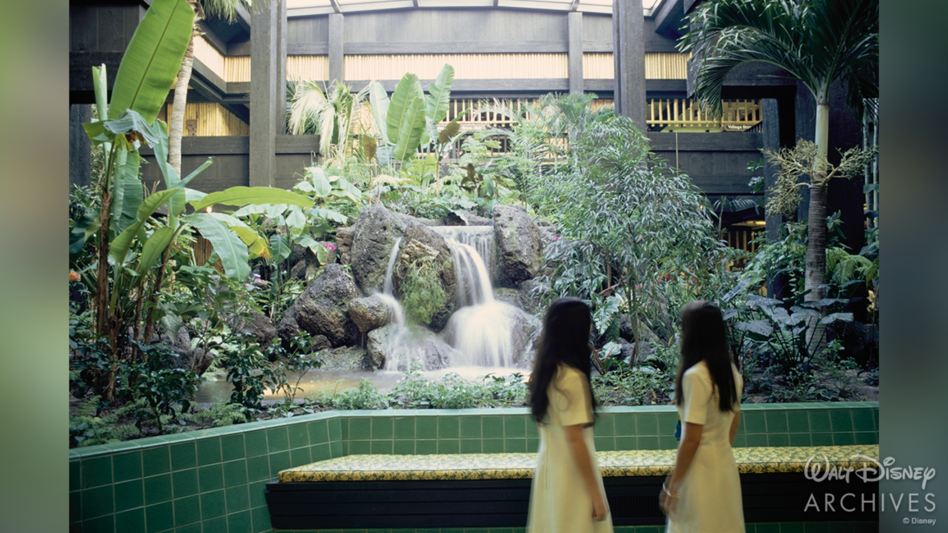 Two young guests look toward the garden and waterfall inside the Great Ceremonial House in November 1971