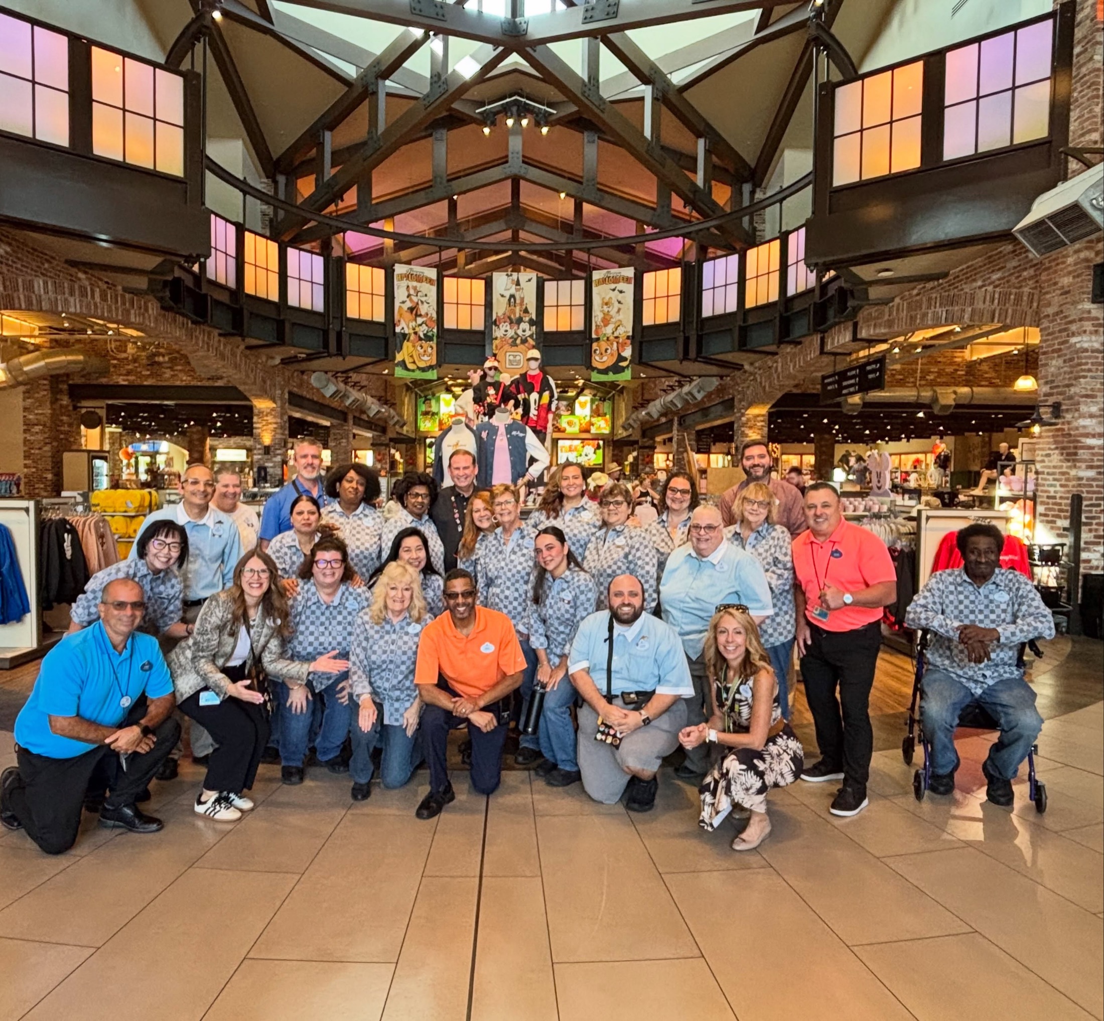 World of Disney Cast Members gather for a group photo inside the Disney Springs shop
