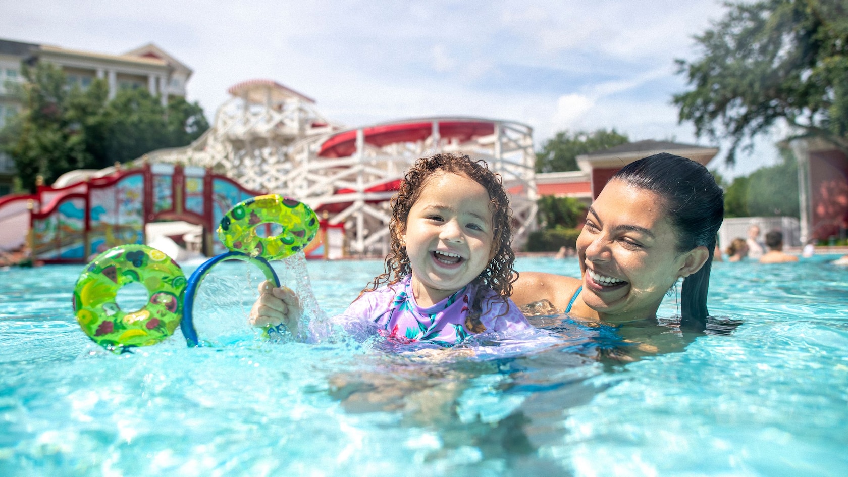 A family swimming at Luna Park Pool at Disney’s BoardWalk Resort
