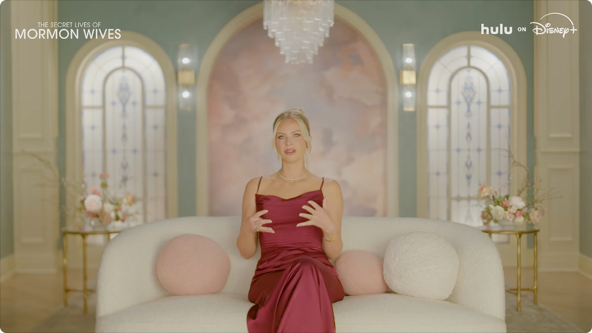 A woman sits on a couch in the official Season 5 trailer for The Secret Lives of Mormon Wives
