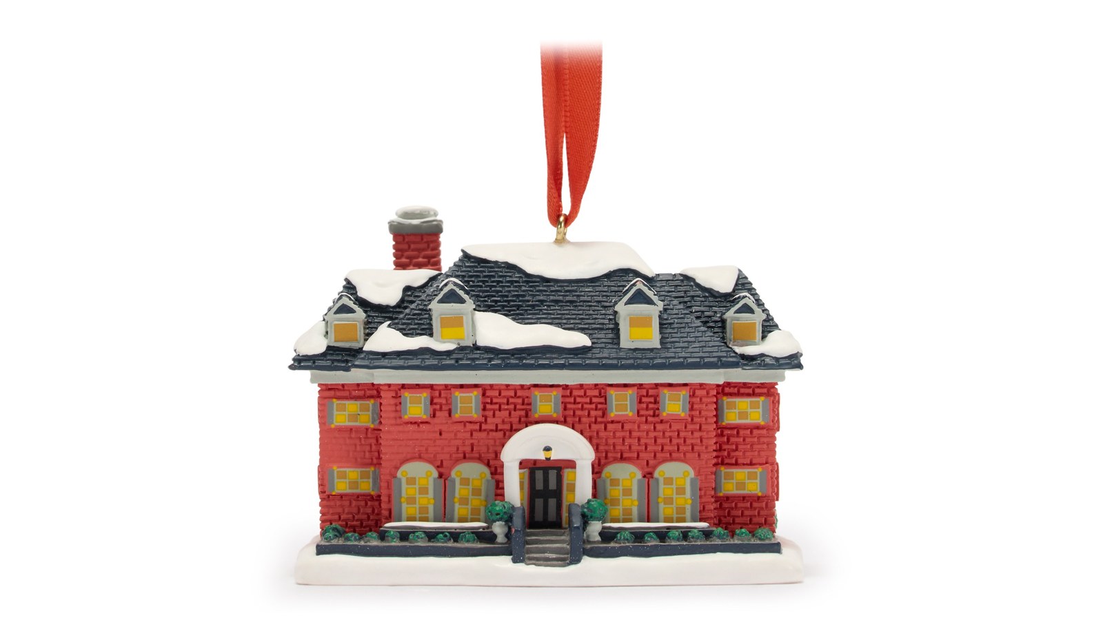 Home Alone McCallister house ornament with a red hanging ribbon