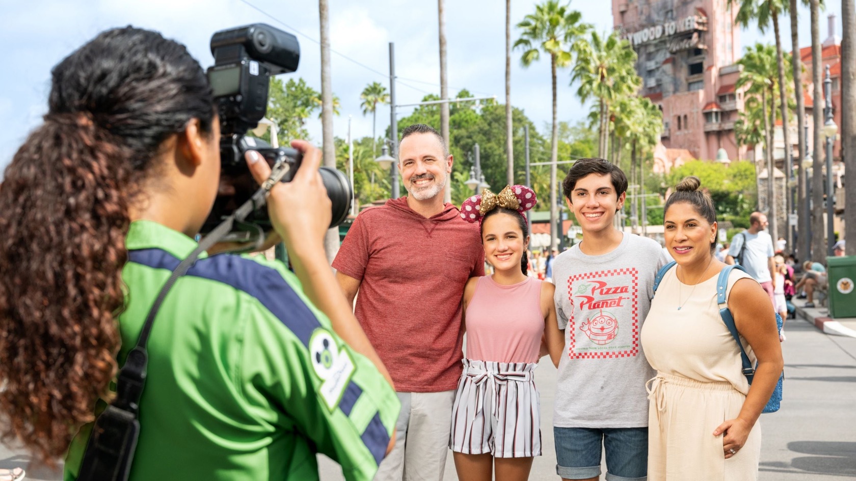 A Disney PhotoPass photographer taking a family portrait at Disney’s Hollywood Studios