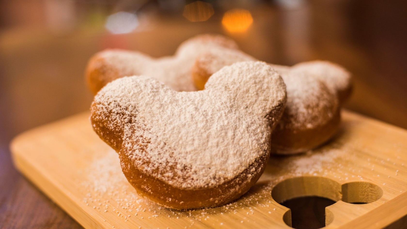 Mickey-shaped beignets dusted with powdered sugar at Scat Cat’s Club – Café