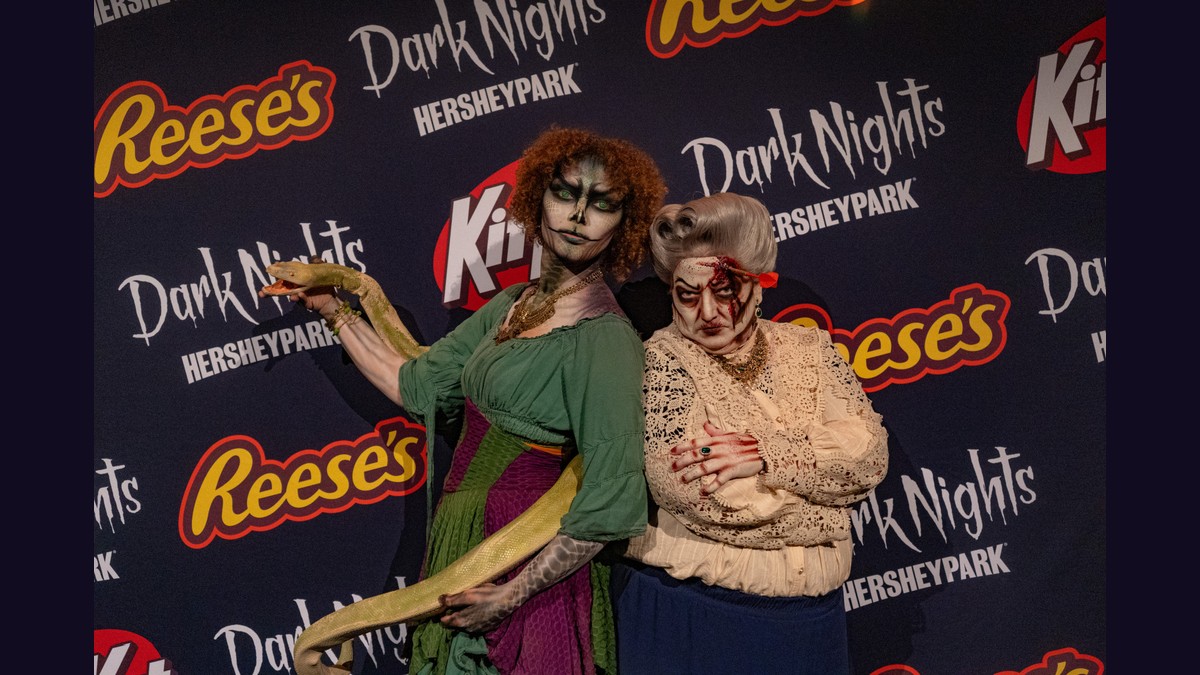 Two Dark Nights characters pose at Hersheypark’s Monster Meet & Shriek photo backdrop