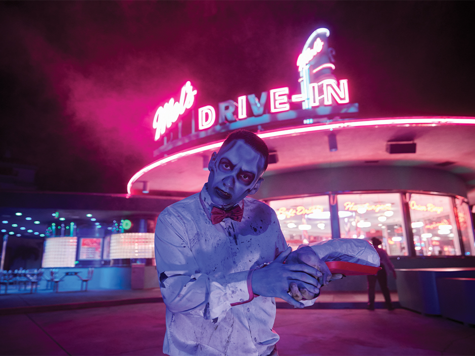 A zombie carhop poses outside Mel’s Drive-In during Halloween Horror Nights