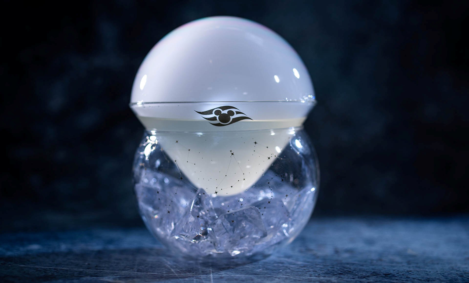 Moonshine drink presented in a crystal sphere with a white aroma bubble
