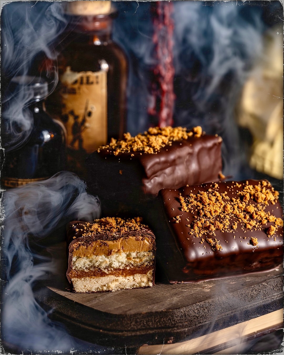 Gideon’s Cookie Butter Shortbread Shadowcakes coated in dark chocolate and topped with crushed Biscoff cookies