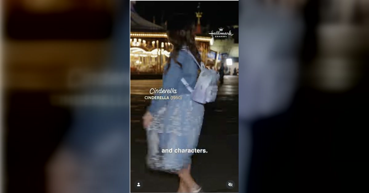 Lacey Chabert wears a pale blue Disney-inspired outfit near a carousel in Hallmark’s Holiday Ever After wardrobe reel