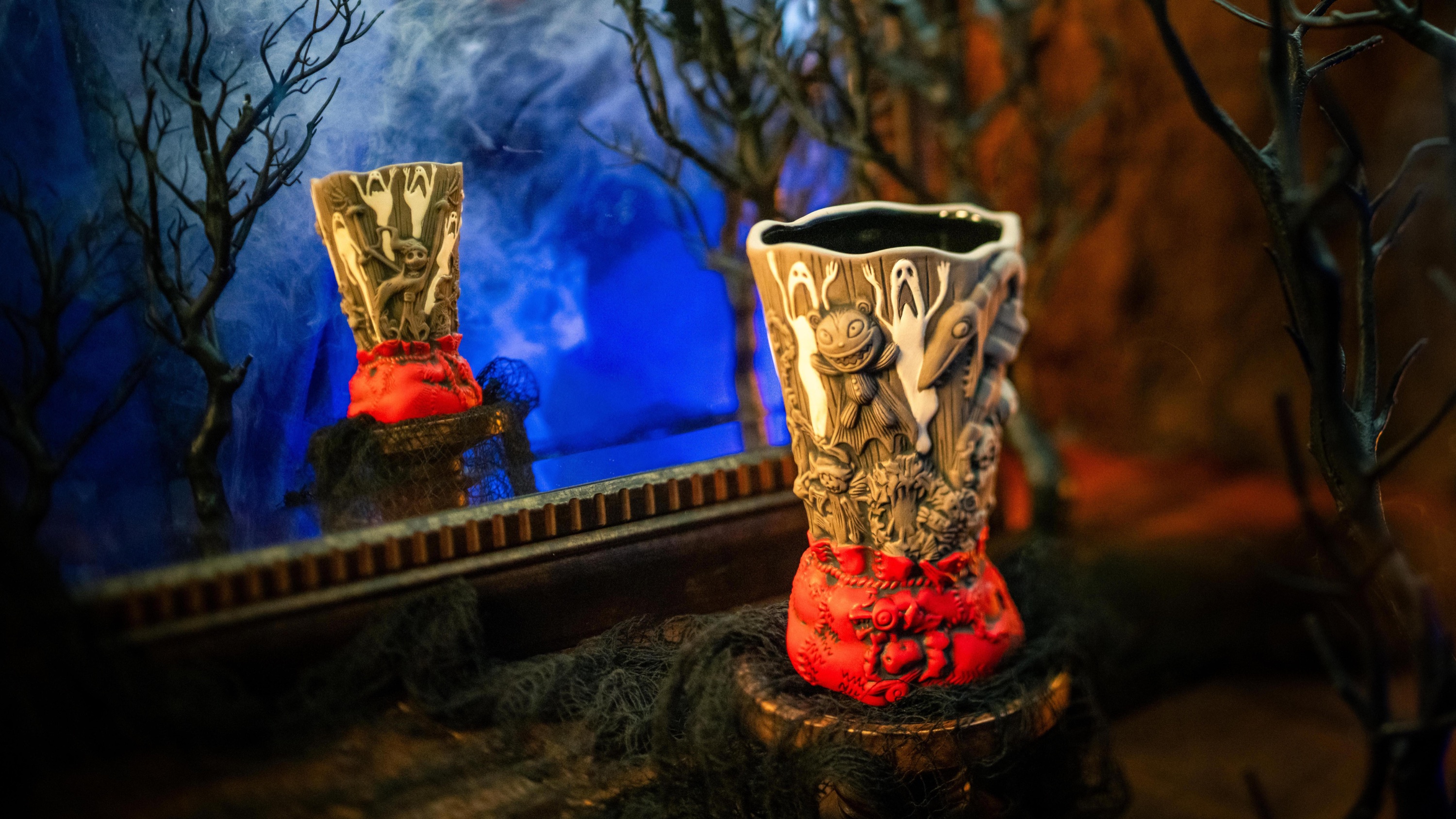 The Jack Skellington mug displayed in a dark forest scene