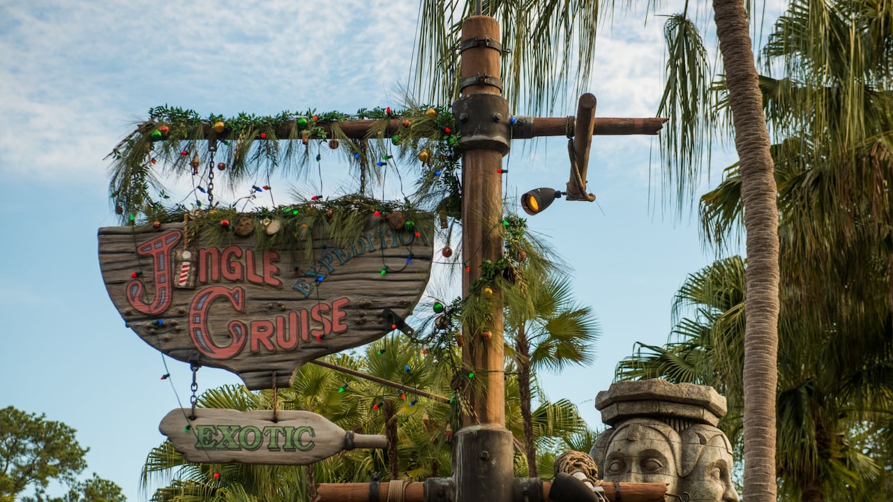 The Jingle Cruise sign decorated with holiday garland at Magic Kingdom