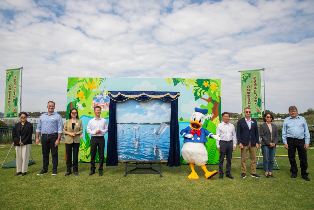 Donald Duck and ceremony guests at the Siberian crane sculpture unveiling