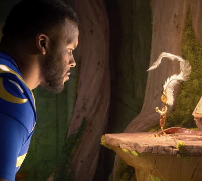 A football player leans toward an animated quill character in Disney Animation’s Hexed video
