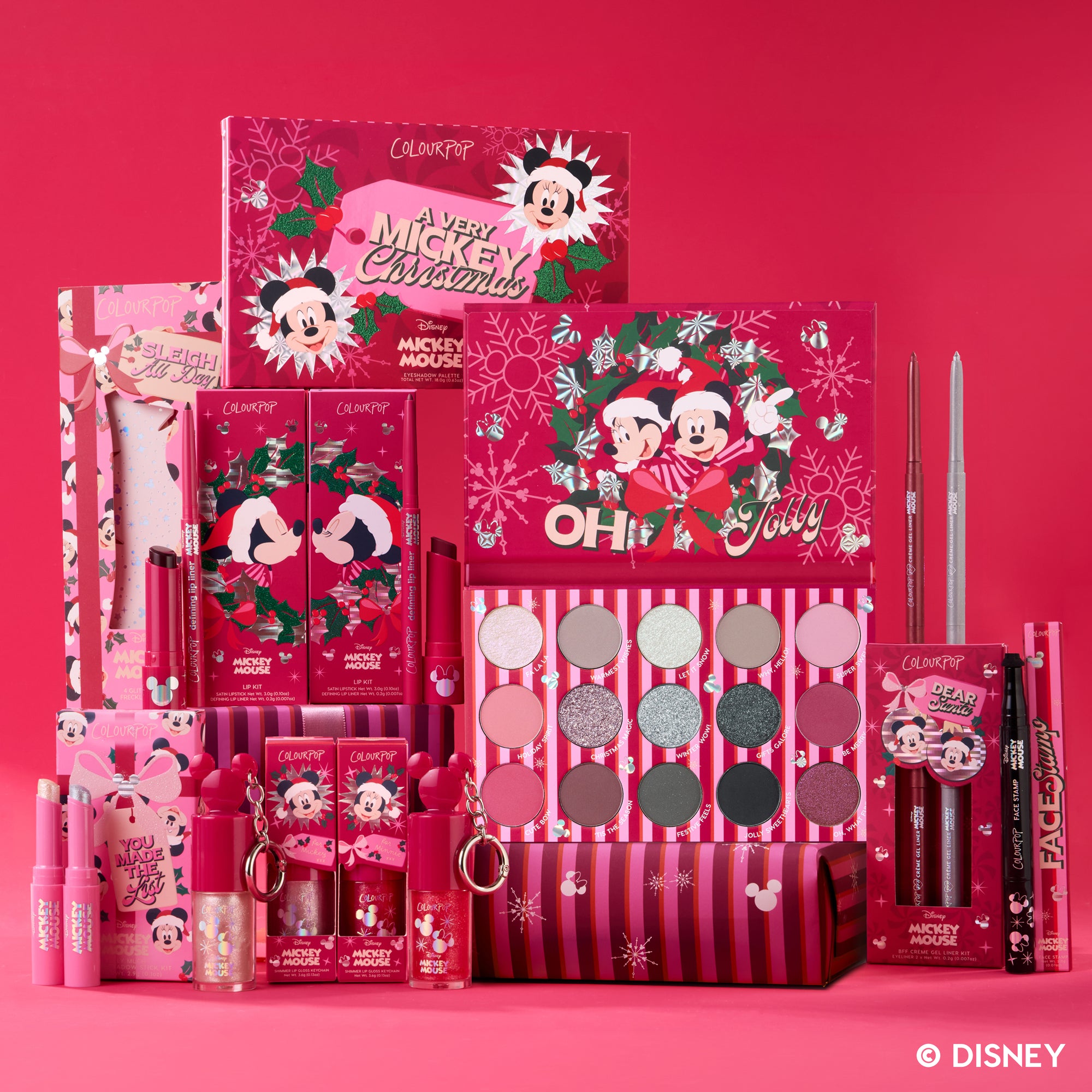 A Very Mickey Christmas ColourPop makeup collection on a red holiday backdrop