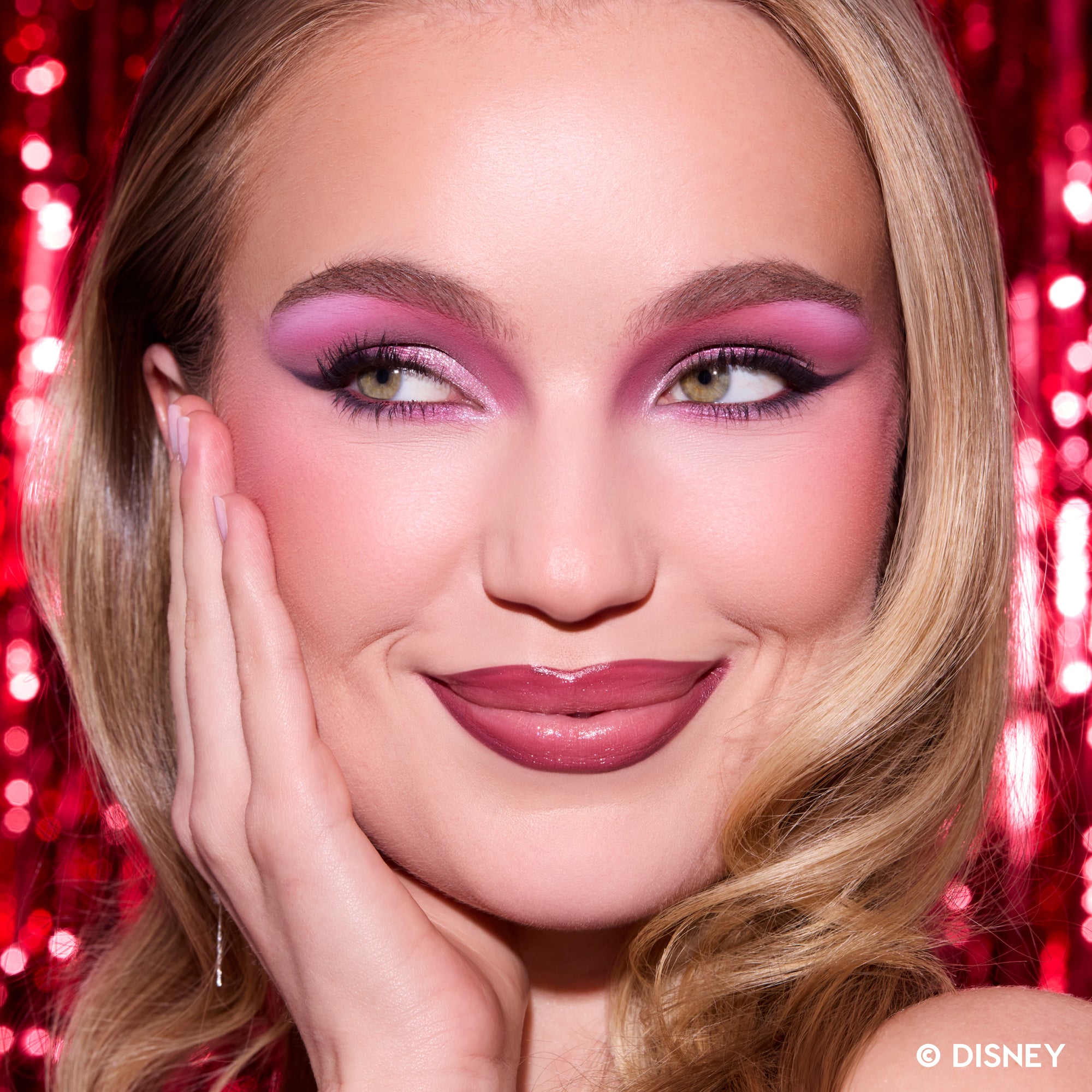 Model wearing pink and mauve eye makeup and a berry lip from A Very Mickey Christmas