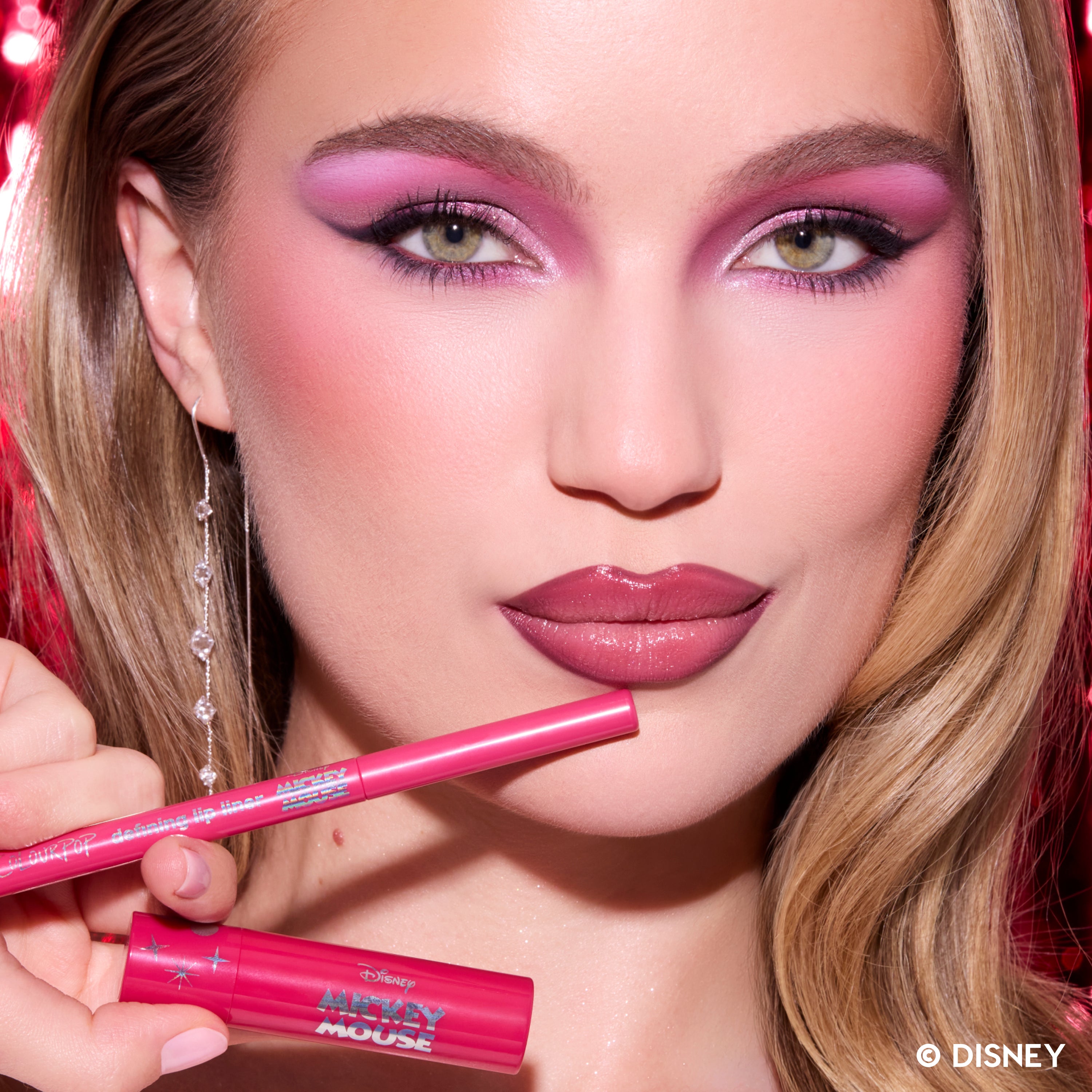 Model wearing the Be Merry & Bright Lip Kit and holding its pink lip liner