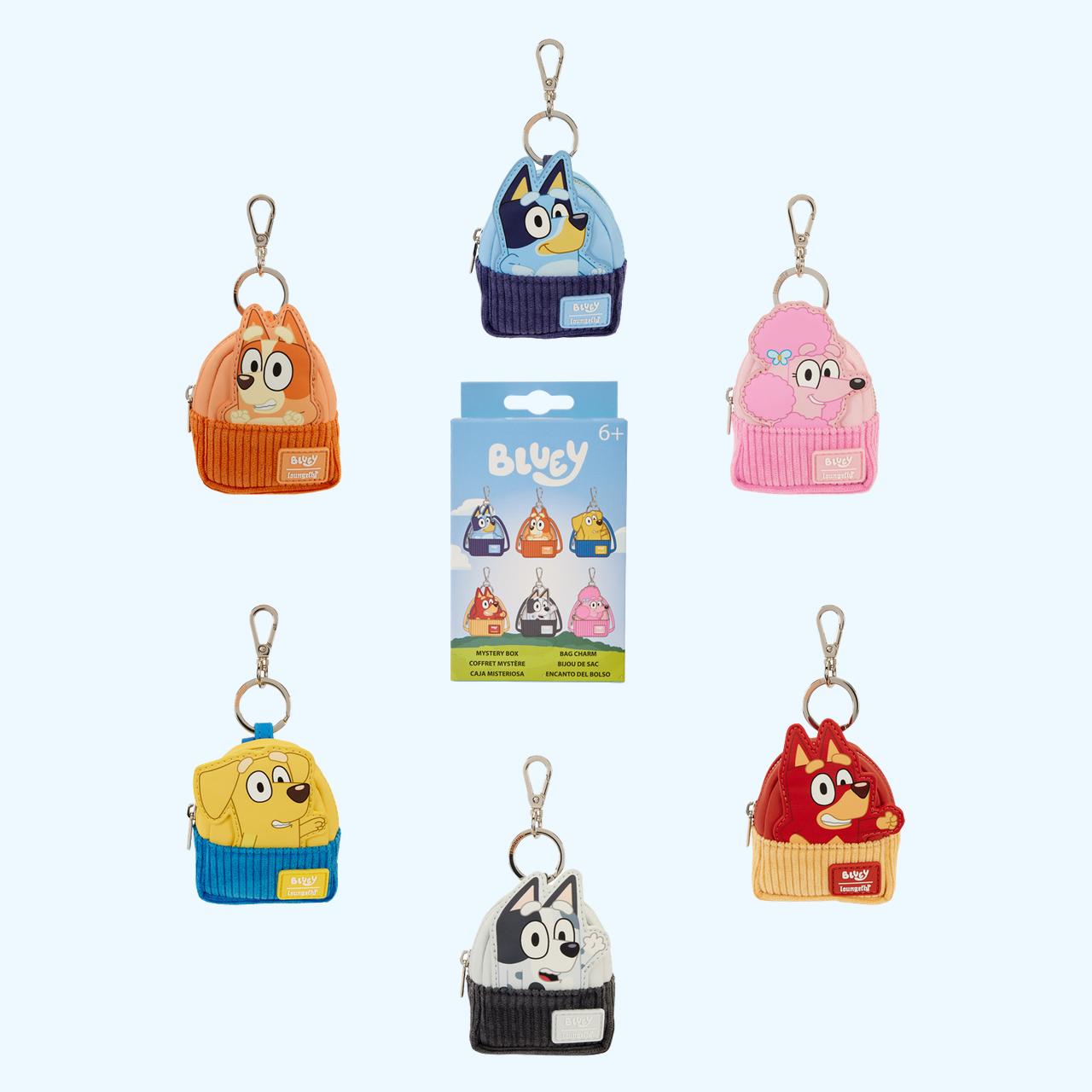 Six Bluey and Friends mini backpack keychain charms arranged around their mystery box