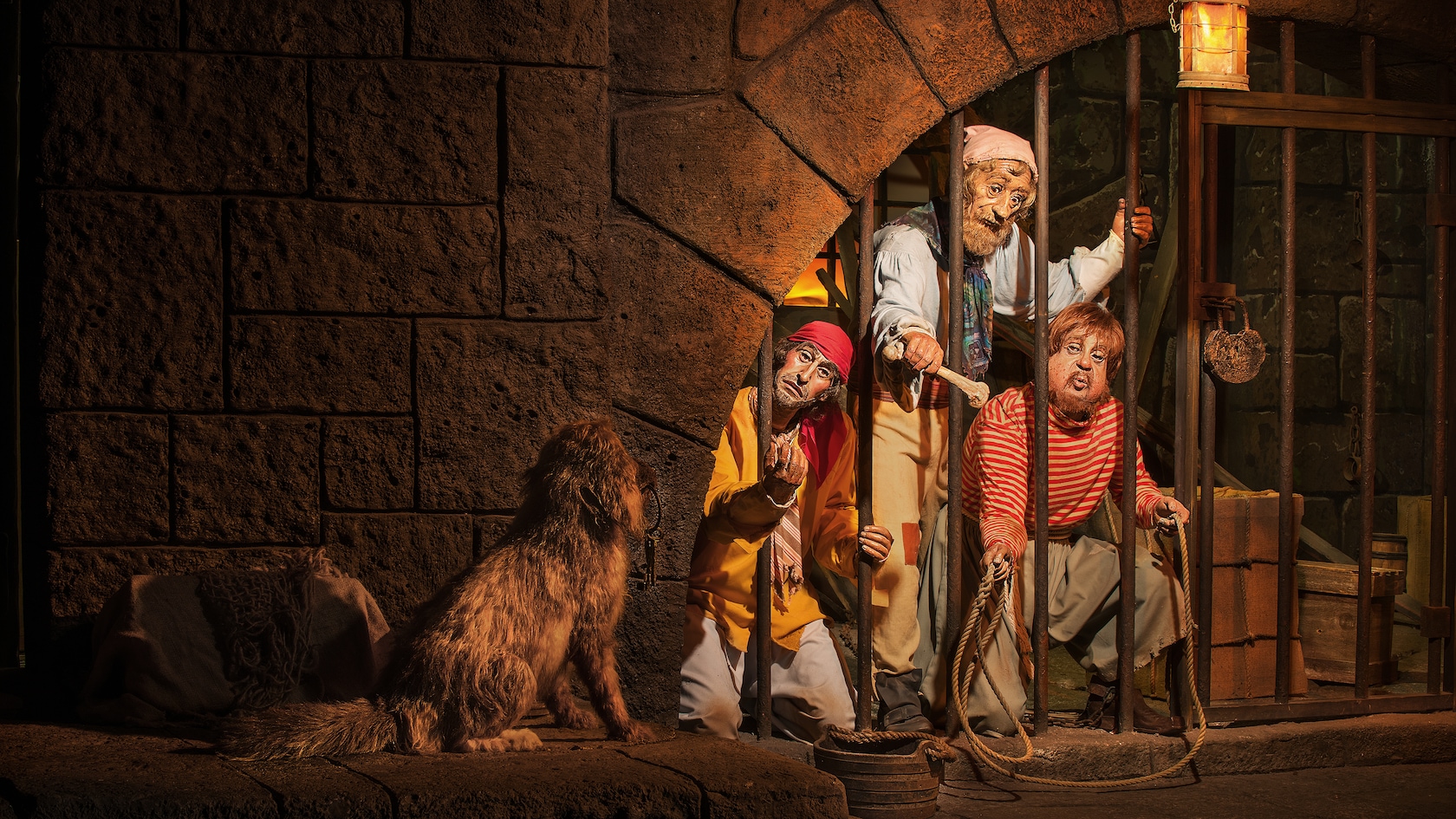 Pirates behind bars in the jail scene at Pirates of the Caribbean in Magic Kingdom