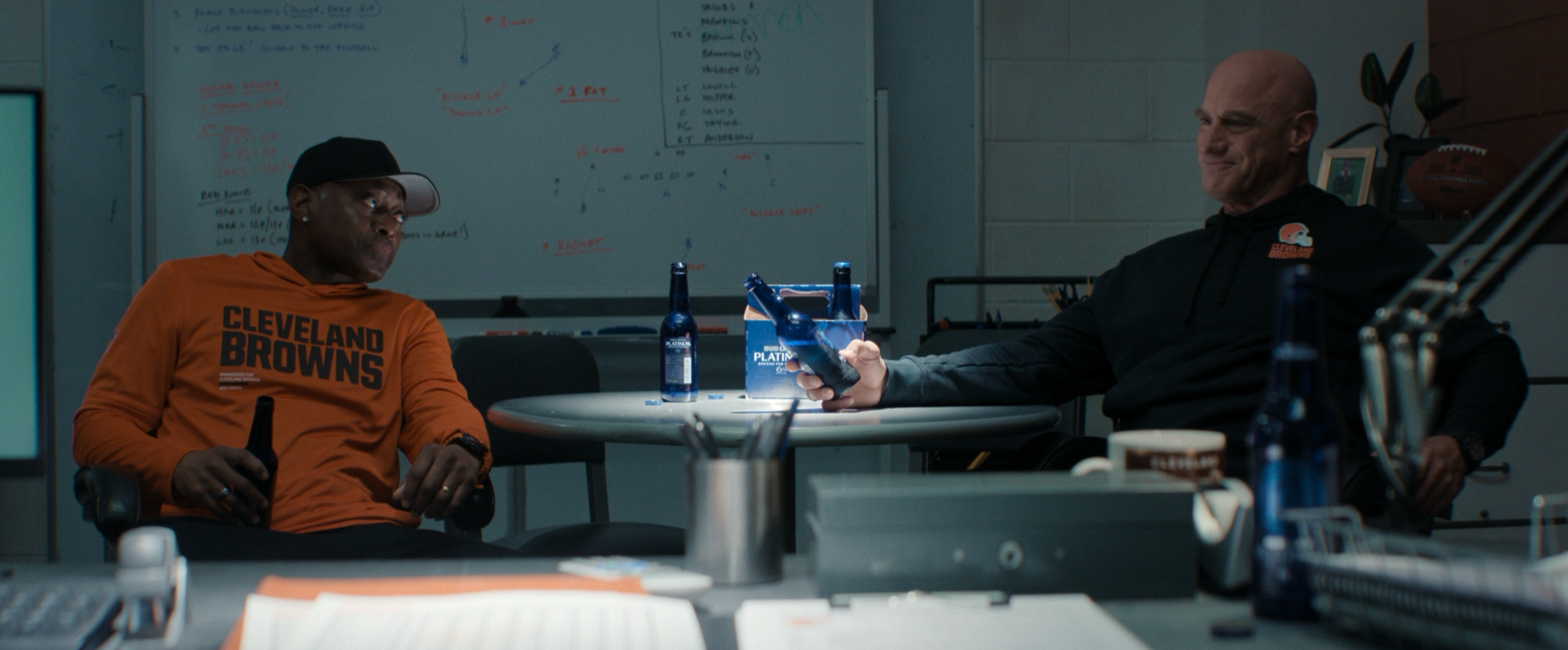 Two Cleveland Browns coaches talk in an office in The Land