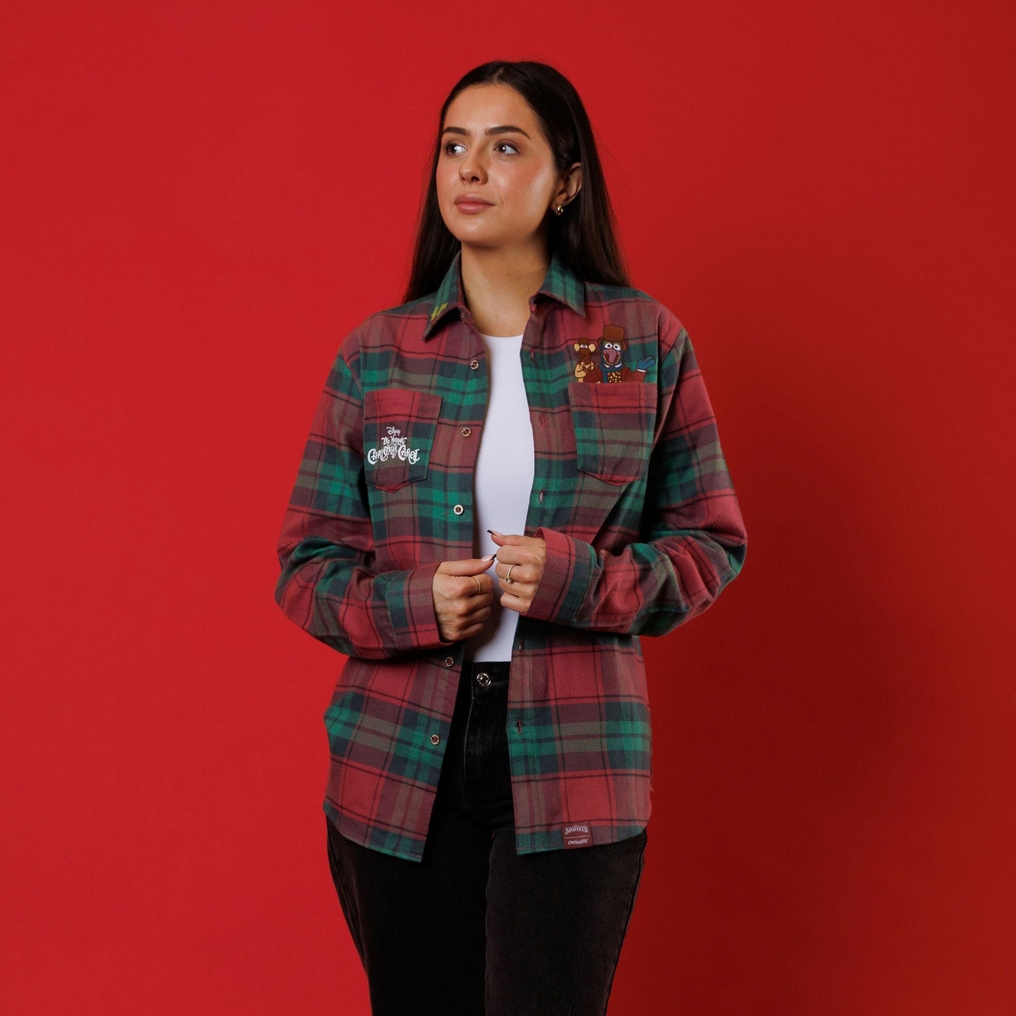 A model wears the Cakeworthy Muppets Christmas Carol flannel open over a white top