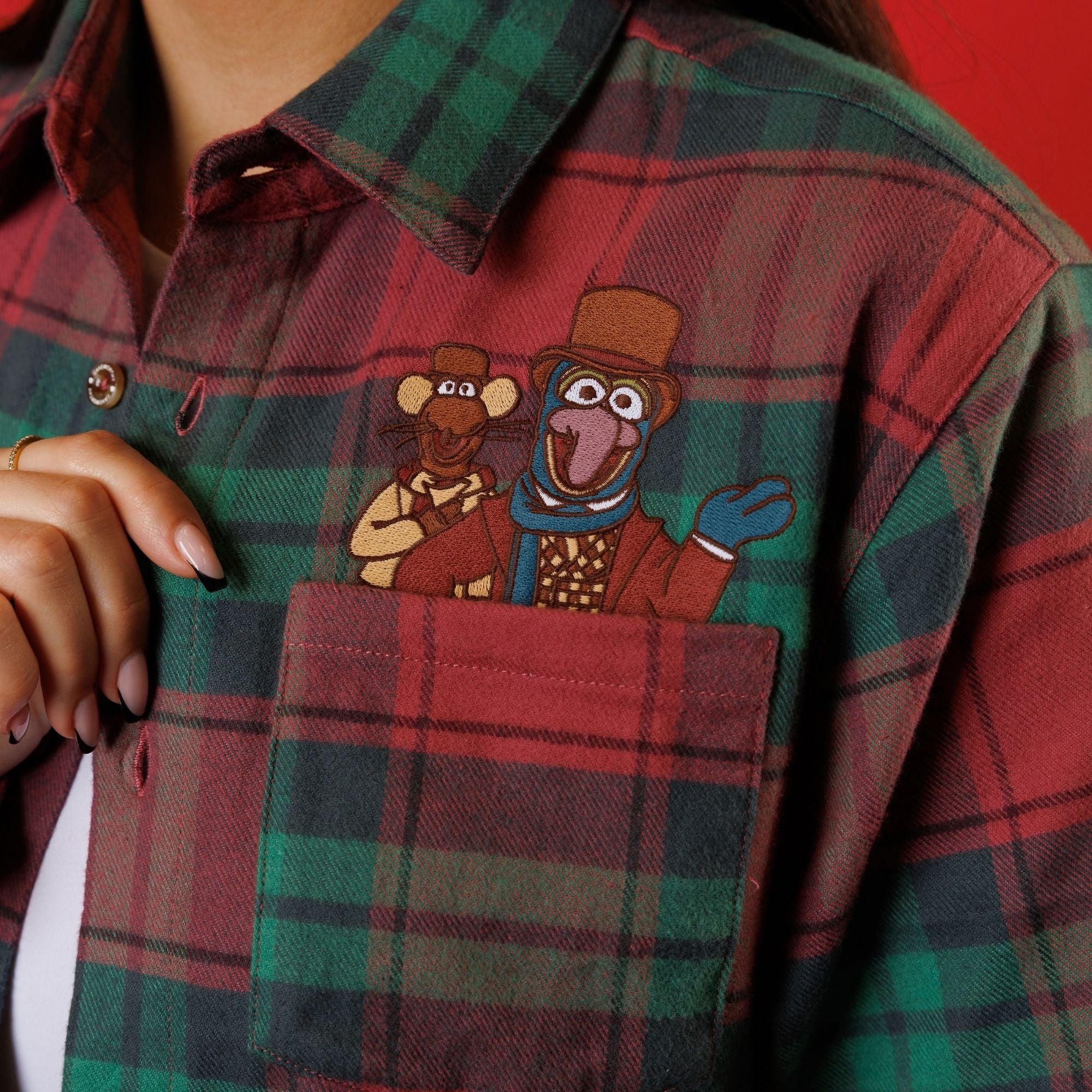 Close view of Gonzo and Rizzo peeking from the flannel front pocket