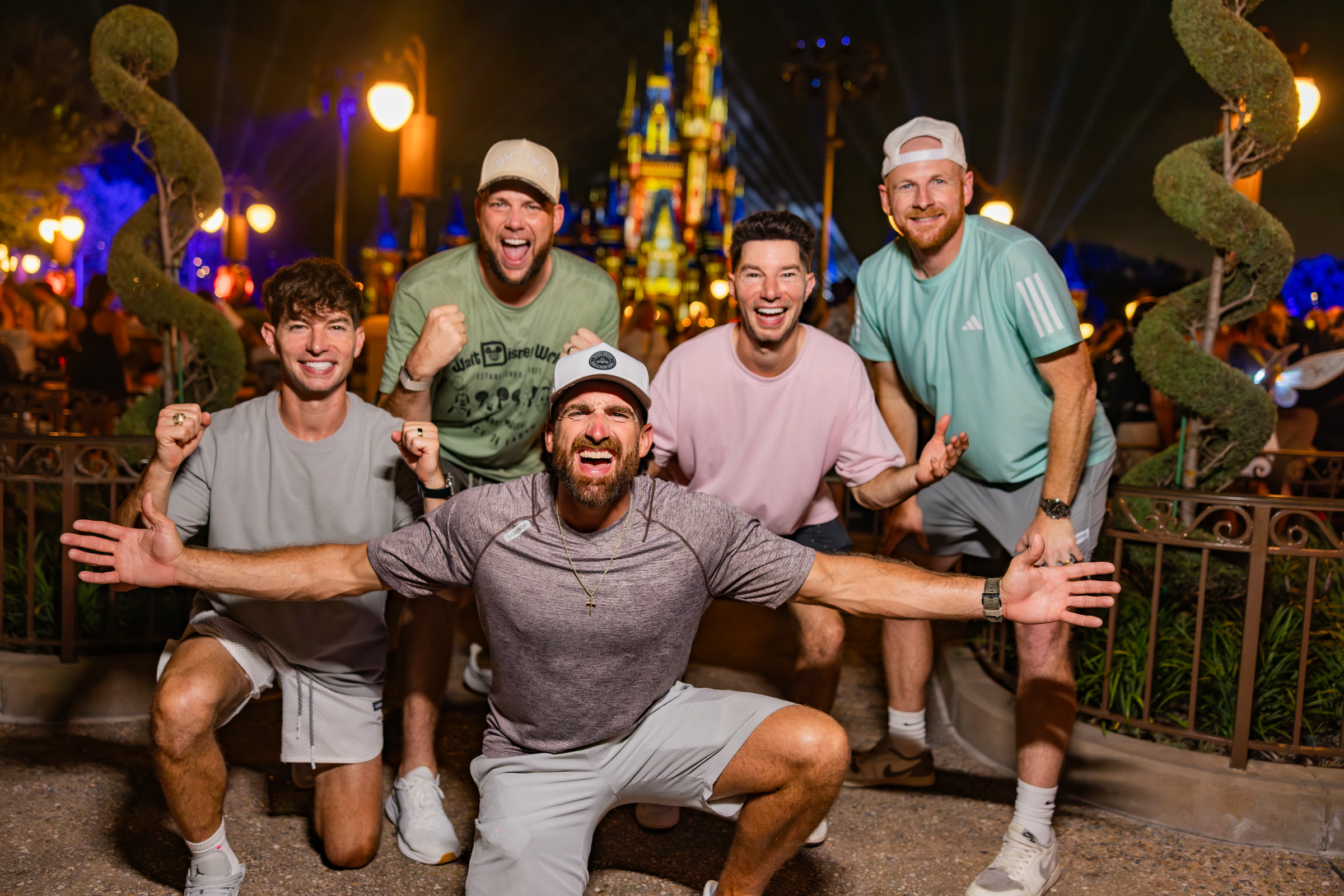 Dude Perfect members pose in front of Cinderella Castle during their Disney partnership announcement