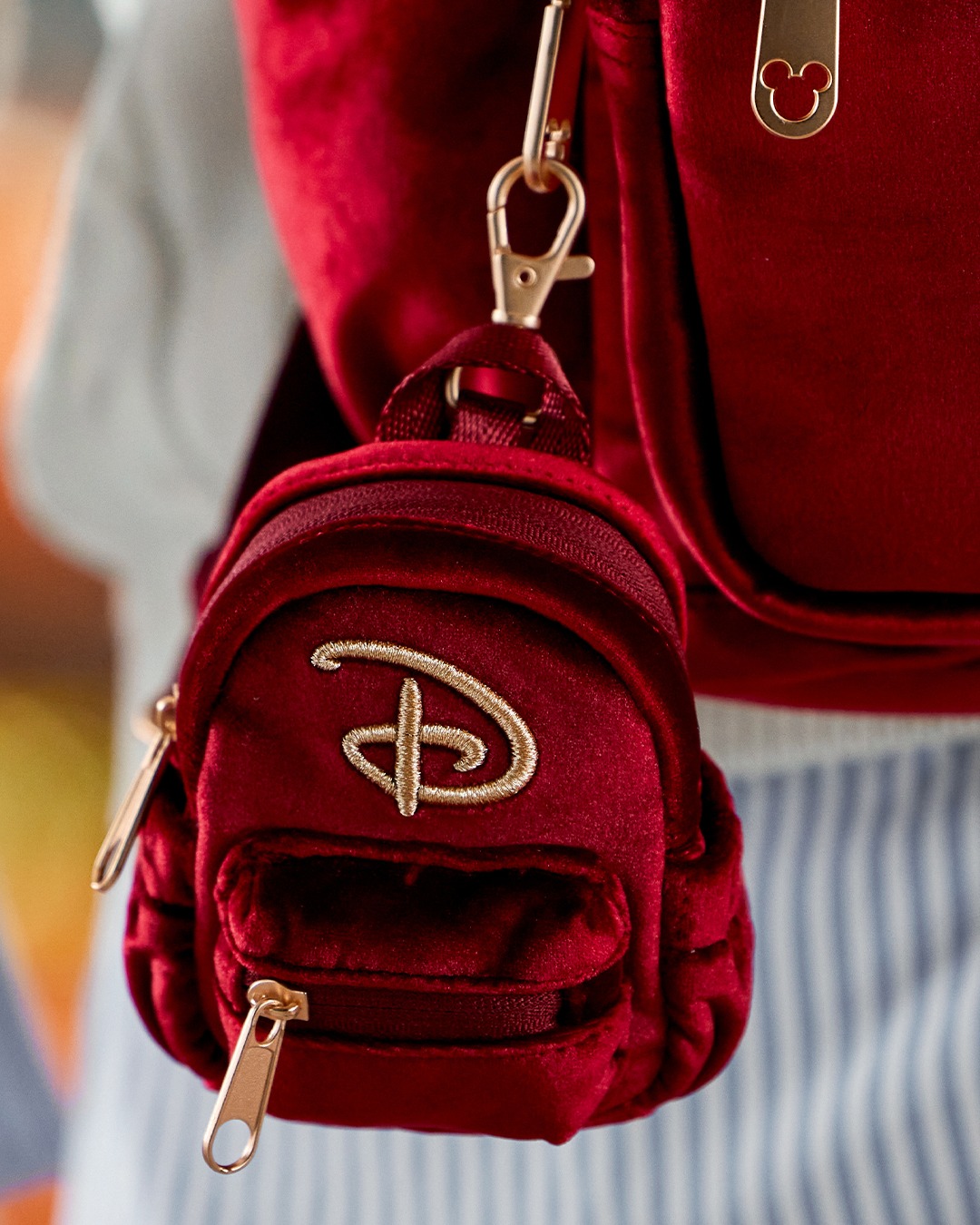 Mini crimson velvet backpack bag charm with gold embroidered Disney D and gold-tone clip