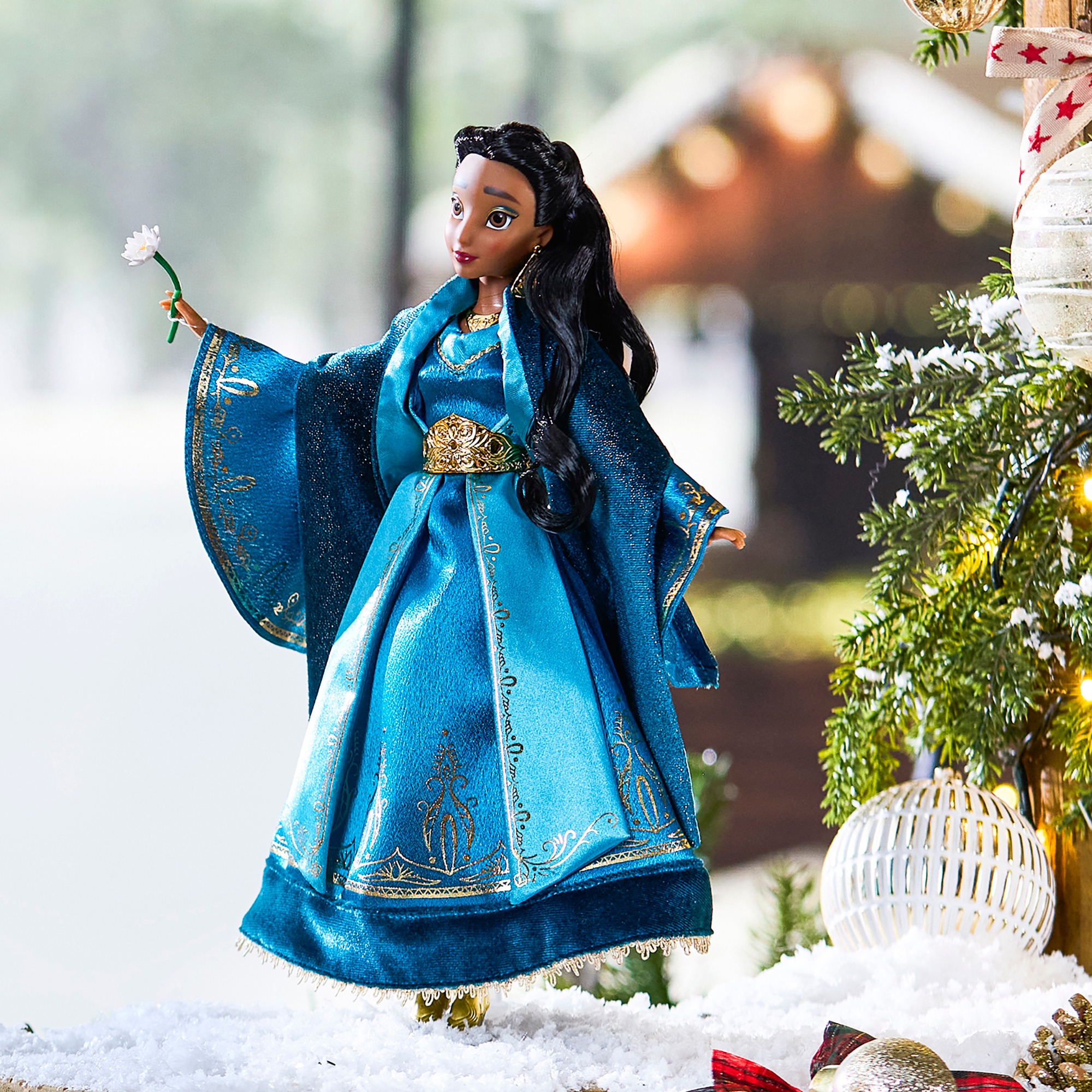 Jasmine Holiday Special Edition 2026 doll in a turquoise hooded gown holding a white lotus flower