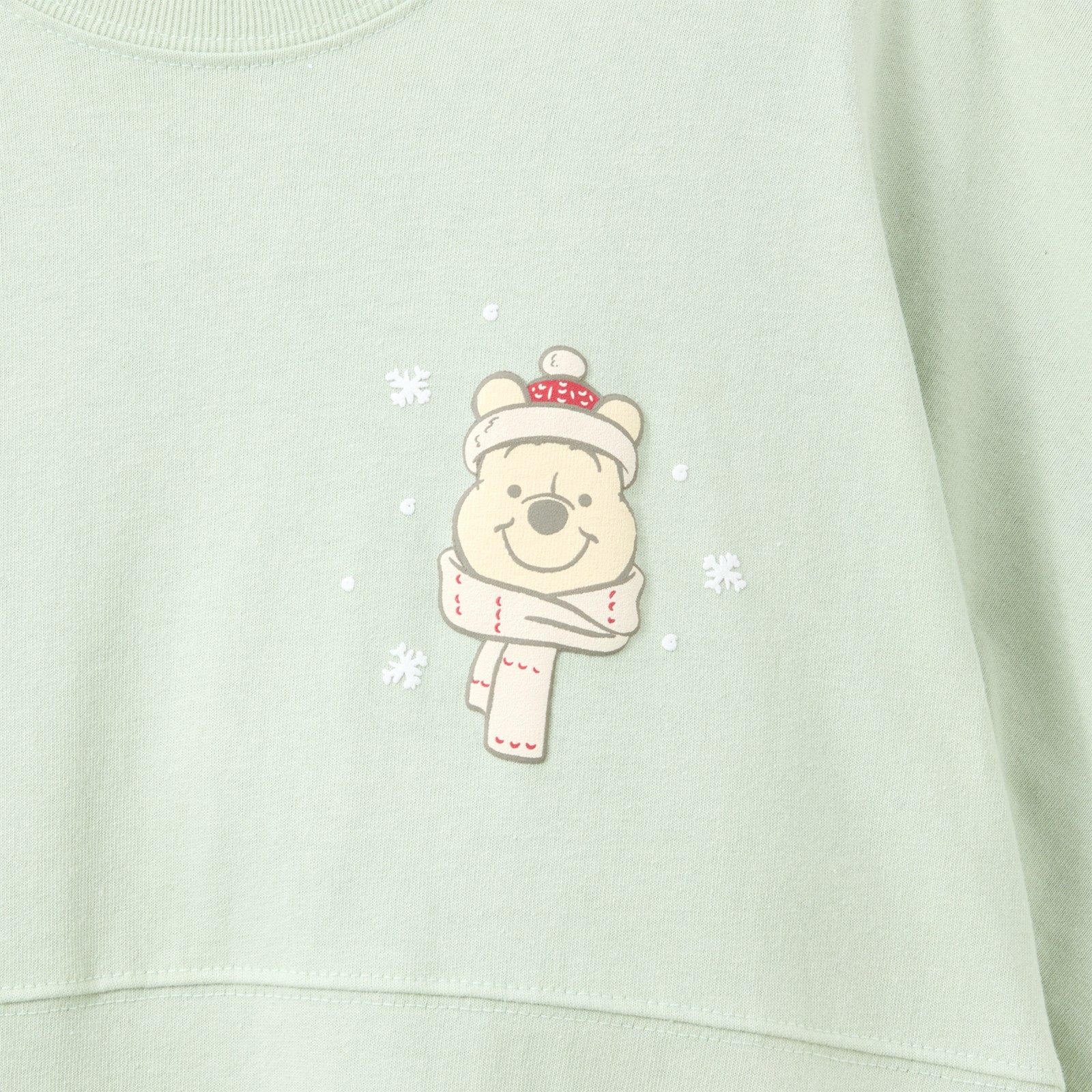 Close view of Winnie the Pooh portrait and snowflakes on the Spirit Jersey