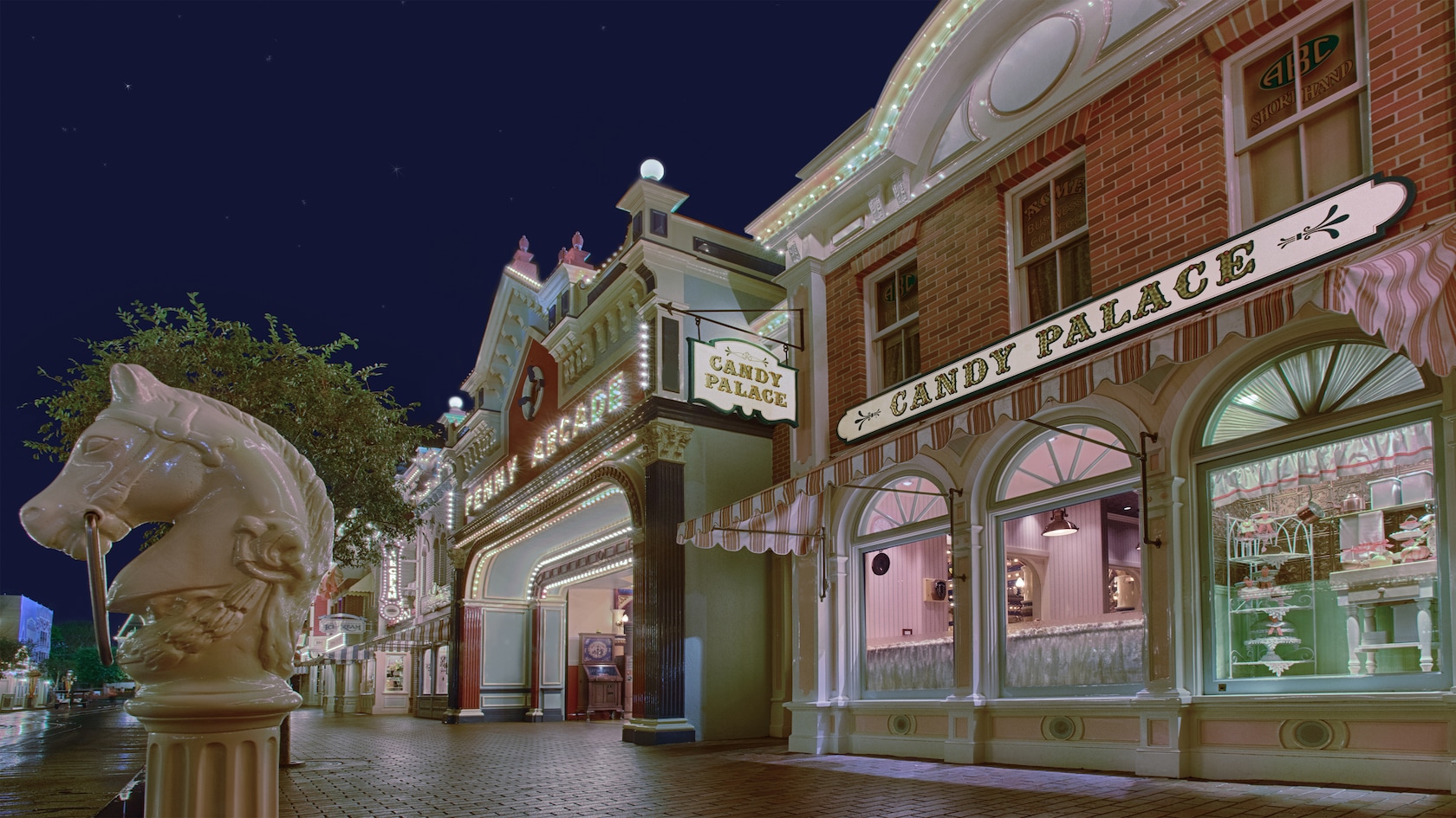 Candy Palace and Penny Arcade illuminated at night on Main Street, U.S.A. at Disneyland Park