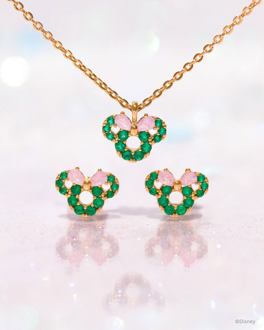 Mickey-shaped wreath pendant and matching stud earrings with green stones and pink bows