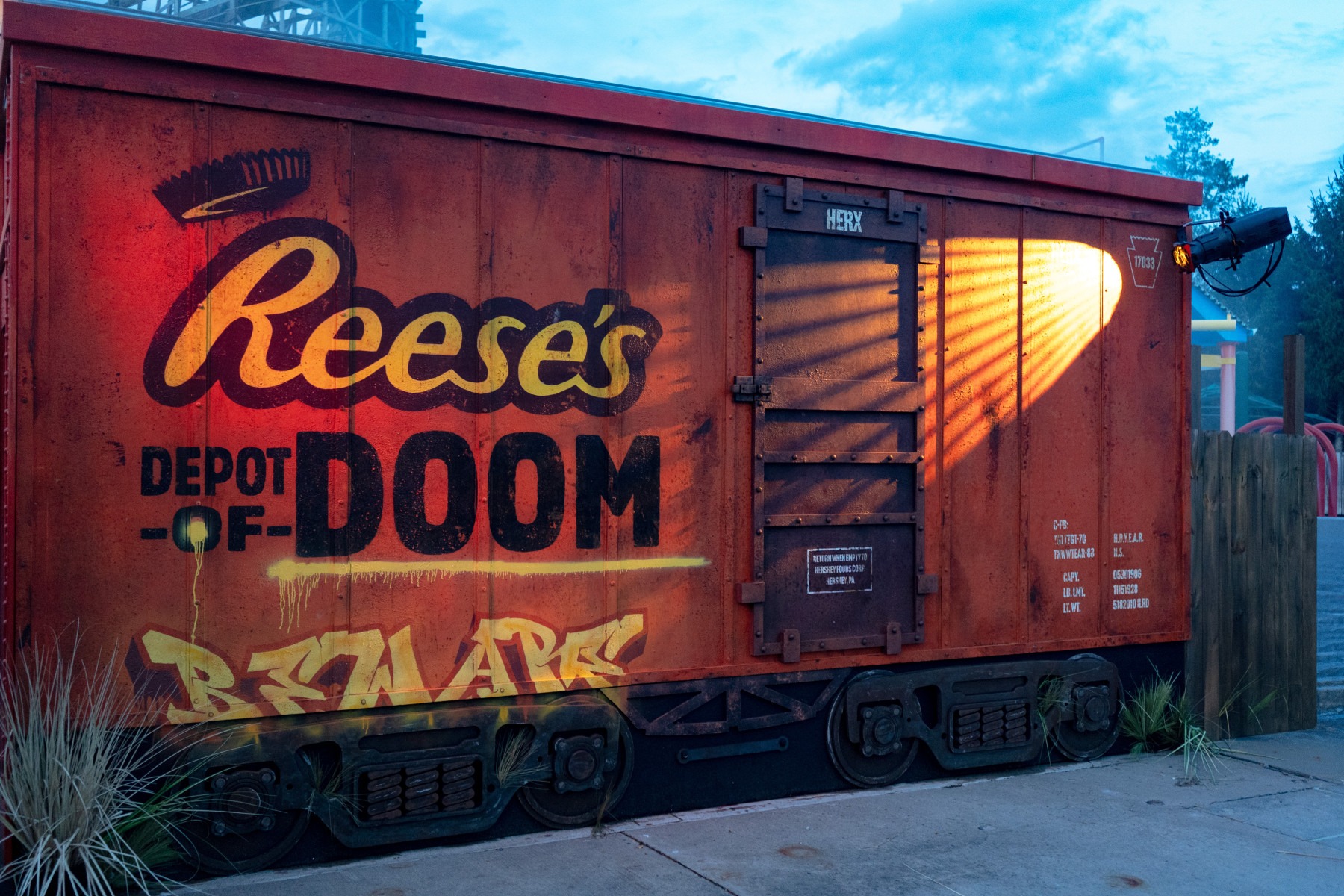 The Reese’s Depot of Doom boxcar at dusk during Hersheypark Dark Nights