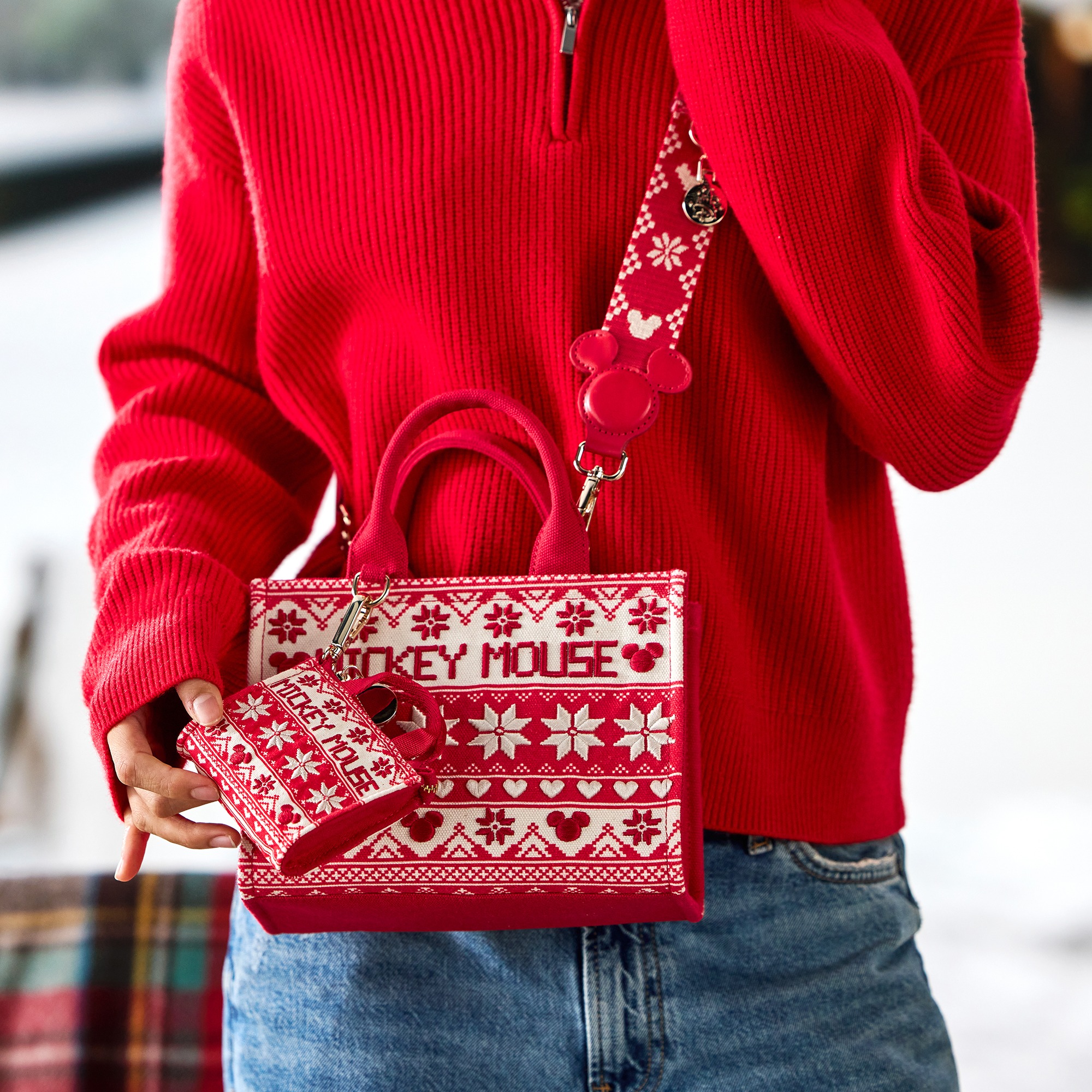 A model wears the Mickey Mouse Fair Isle micro tote bag charm