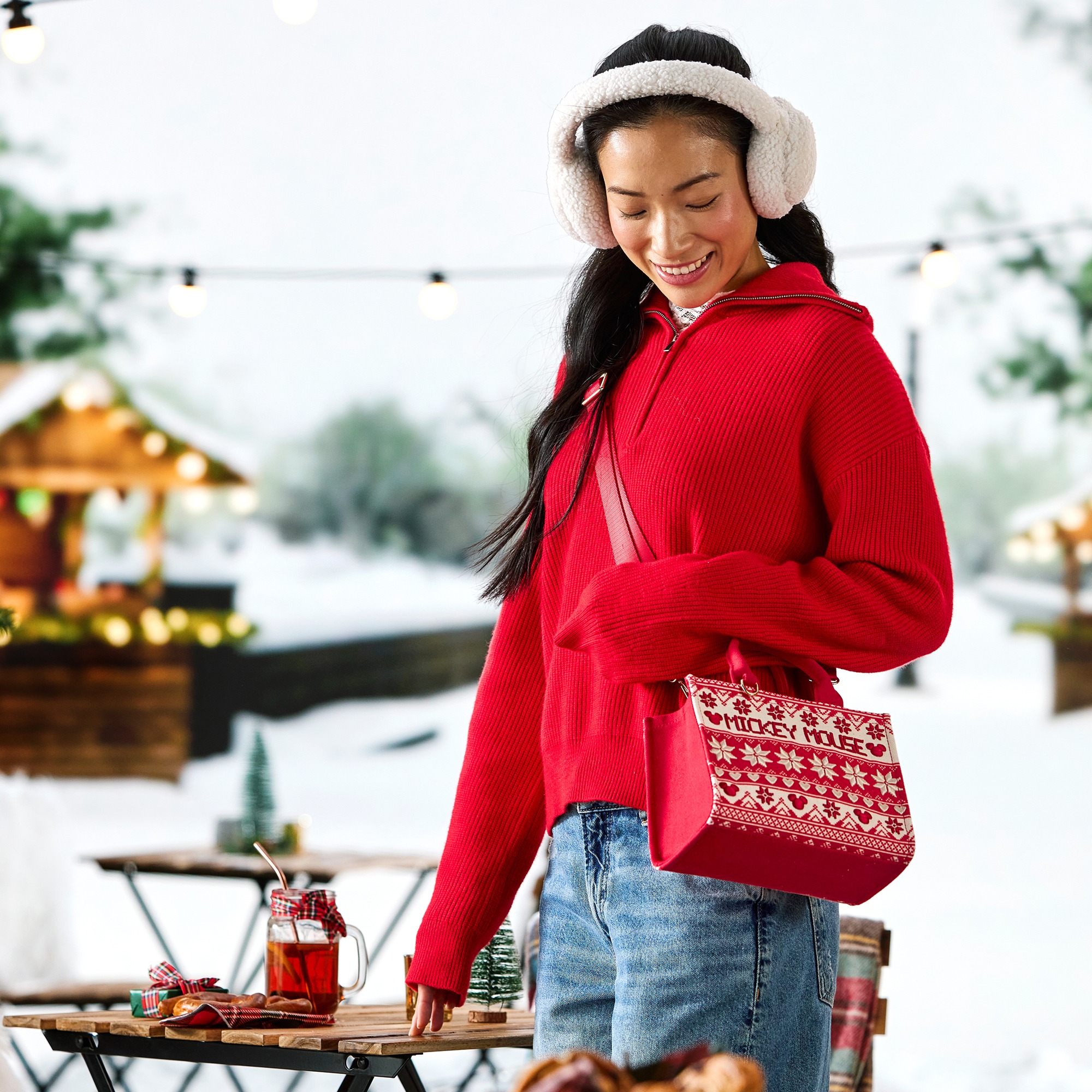 A model wears the Mickey Mouse Fair Isle mini tote as a crossbody bag