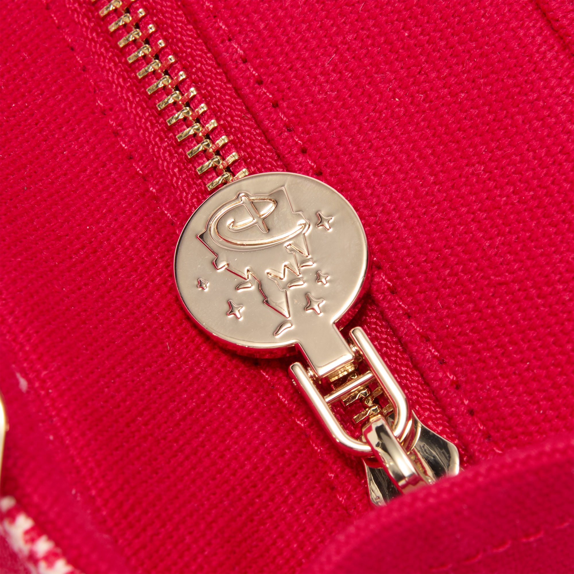 Close view of the tote’s goldtone Mickey zipper pull